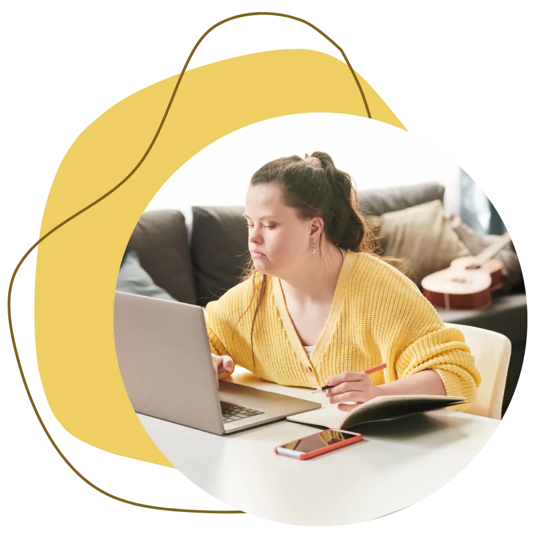 A young down syndrome woman is using her laptop to make an online enquiry